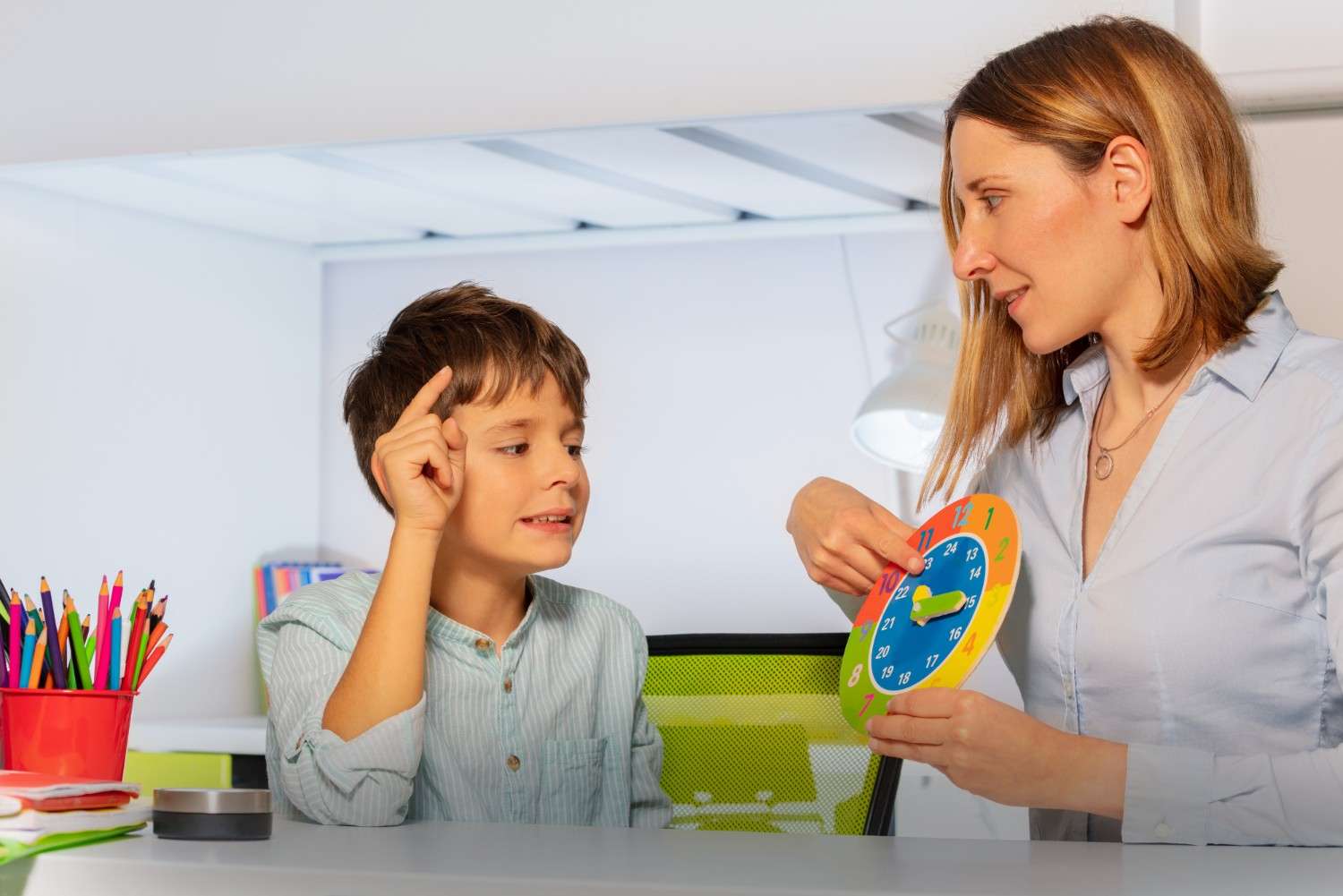 Montessori teacher teaching a student patiently 