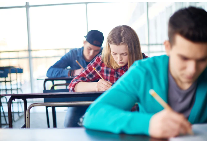A picture of a exam hall and students are writing exam