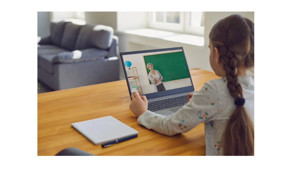 A young girl attending online class